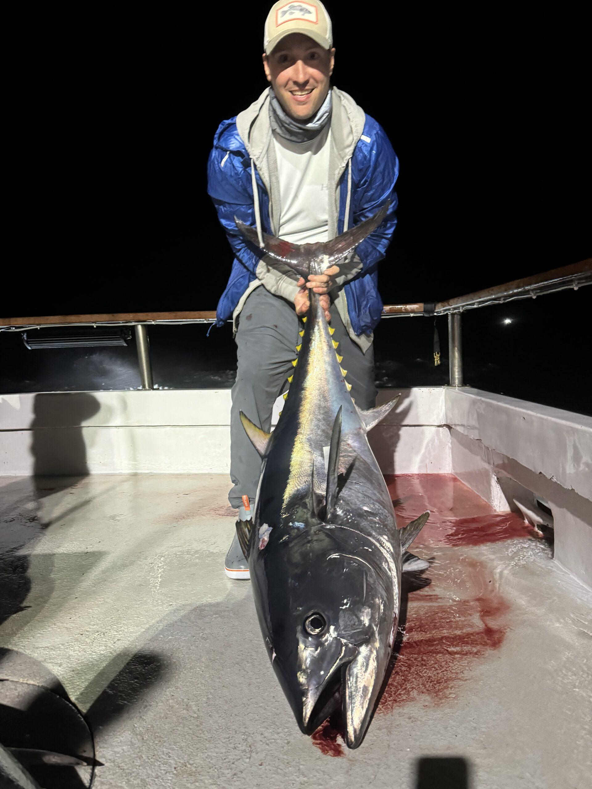 Angler holding a 70 lb. bluefin tuna.
